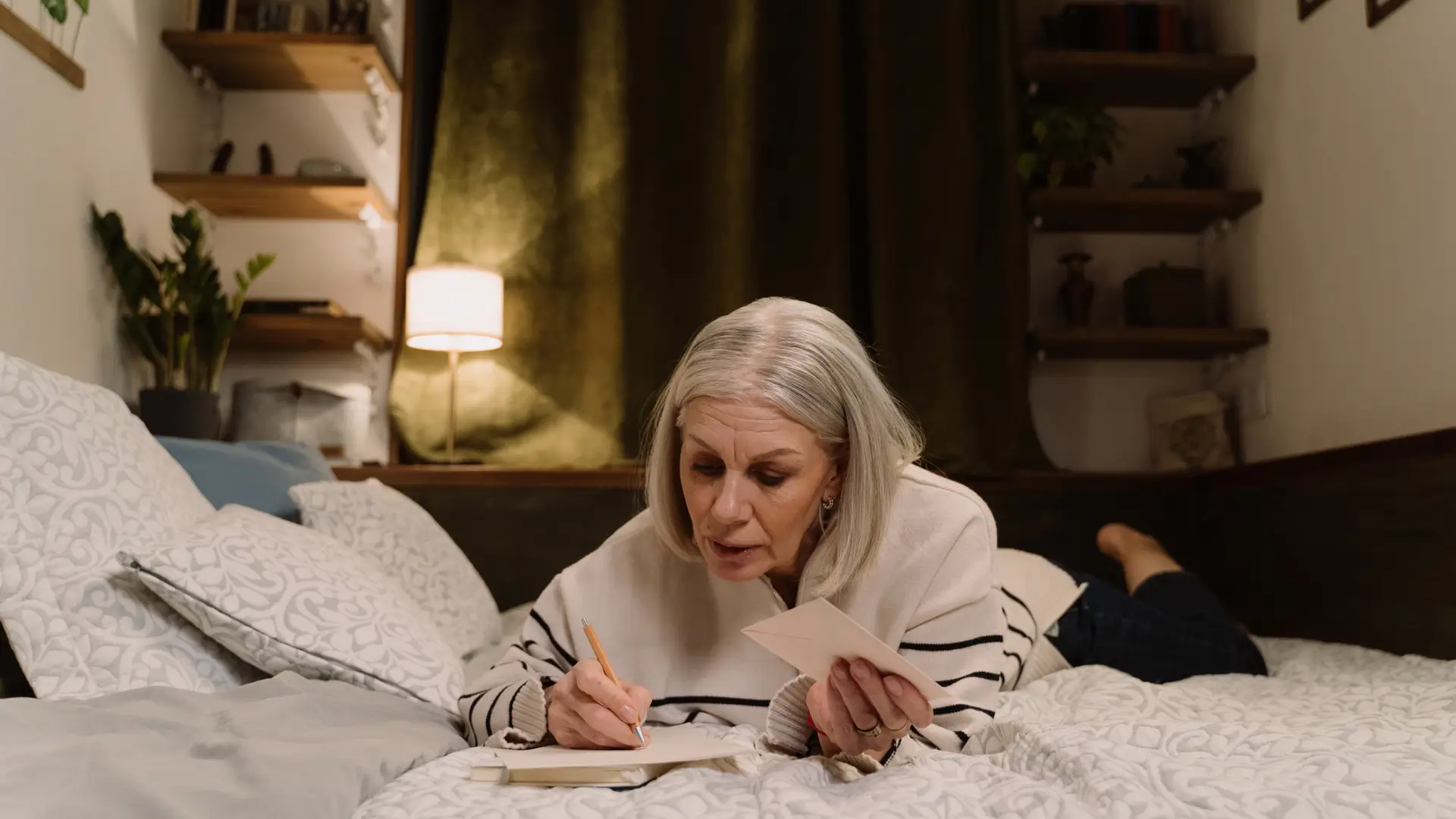 elderly woman in room writing