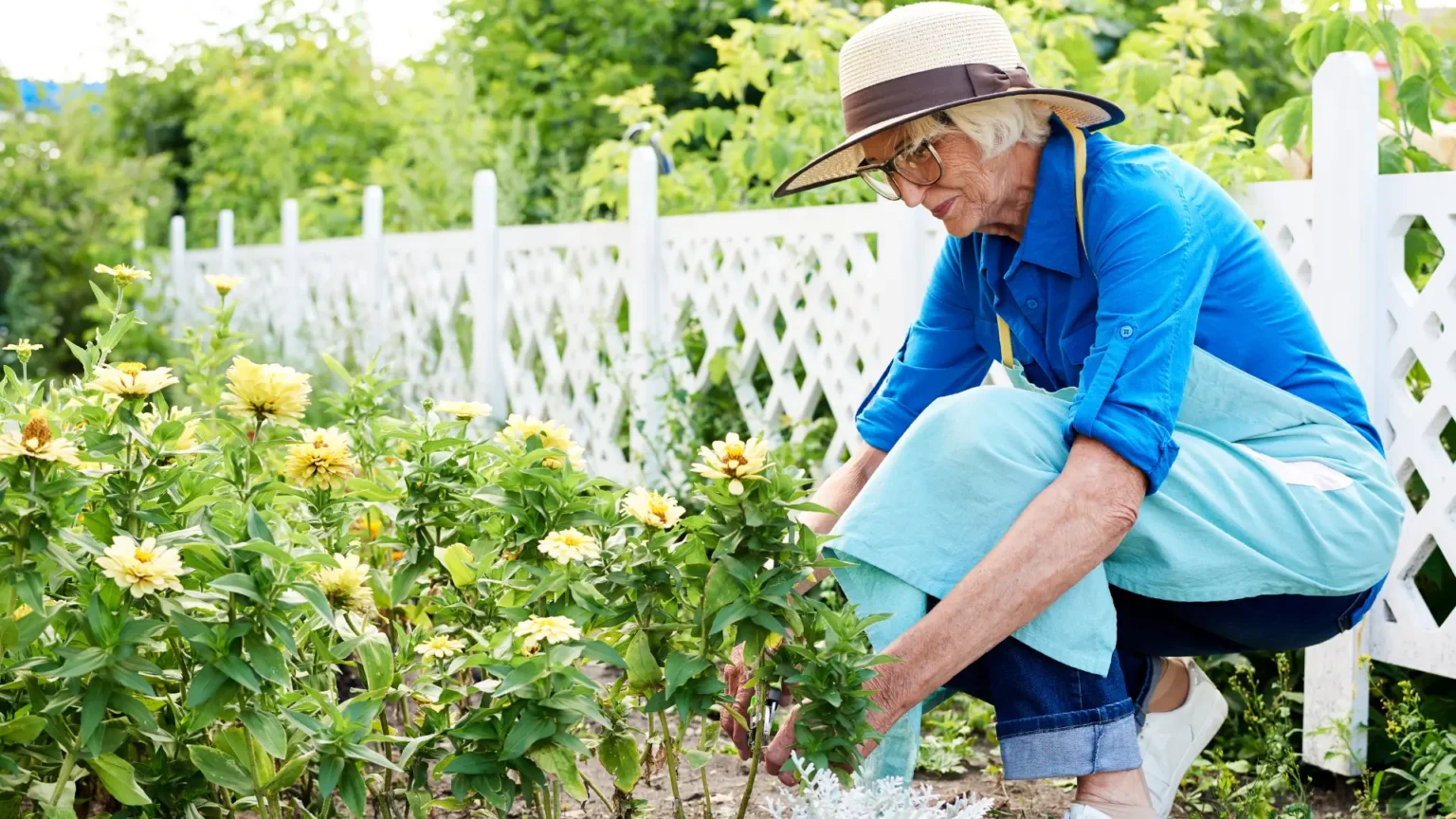 elderly woman happily tending to her garden